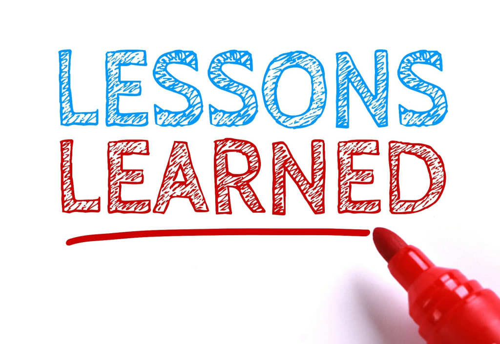 A white background with the words "lessons learned" written in red and blue markers.