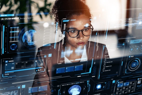 Focused businesswoman analyzing futuristic digital data interface with holographic charts and global network visuals, representing artificial intelligence and data analytics technology.