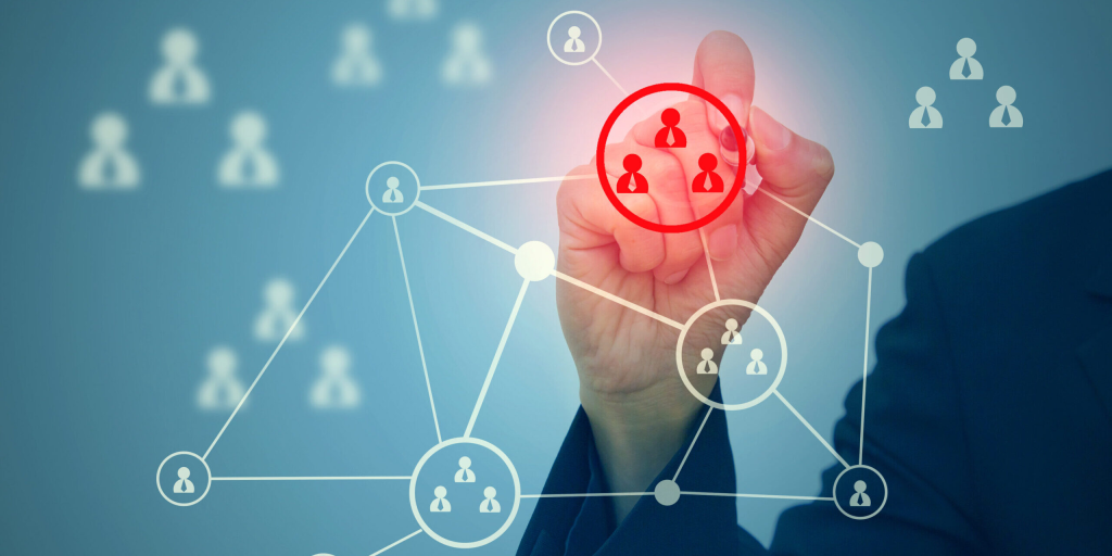 A hand interacting with a network diagram, highlighting a group of three people in red.