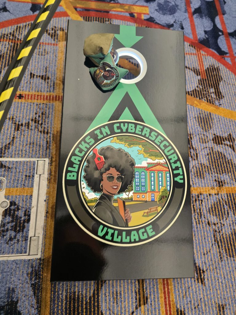 Blacks in Cybersecurity Village custom cornhole board with green accents.